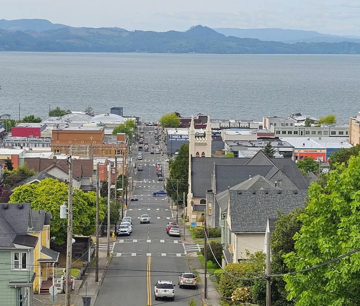 Downtown Astoria rooftops and the Columbia River seen from the hillside