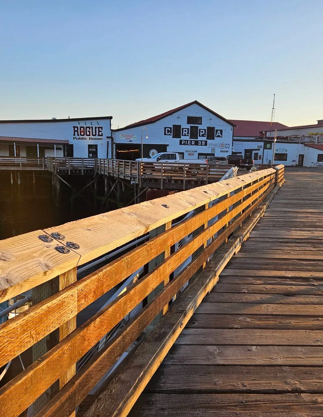 Pier 39 boardwalk and the Rogue Ales Public House at sunset