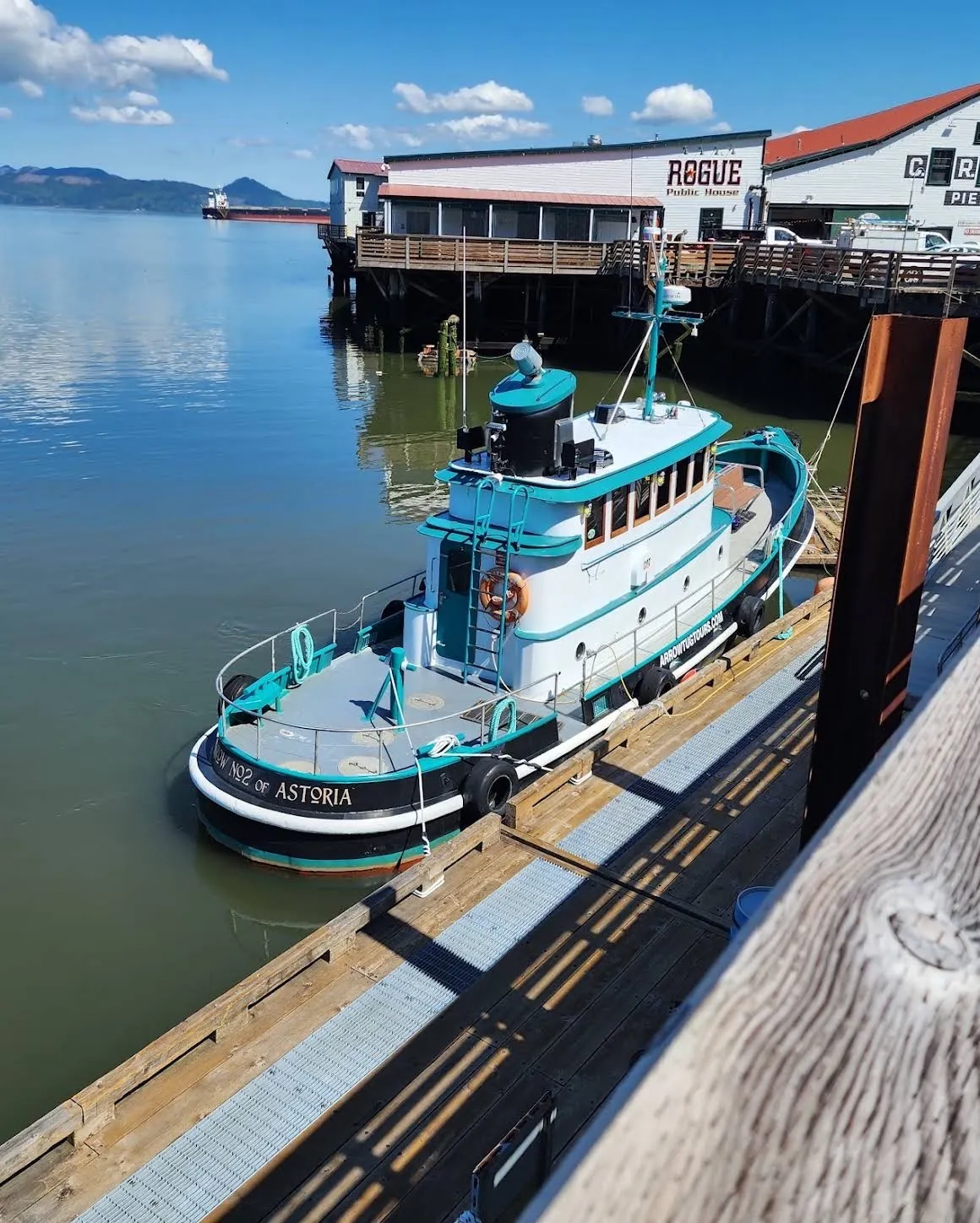 A moored tugboat on the Columbia River beside Pier 39 in Astoria