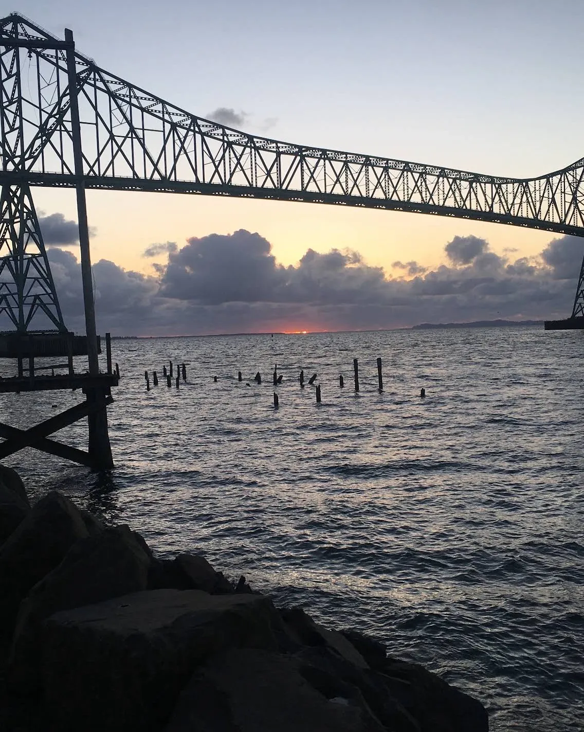 The Astoria-Megler Bridge silhouetted at sunset over the Columbia River