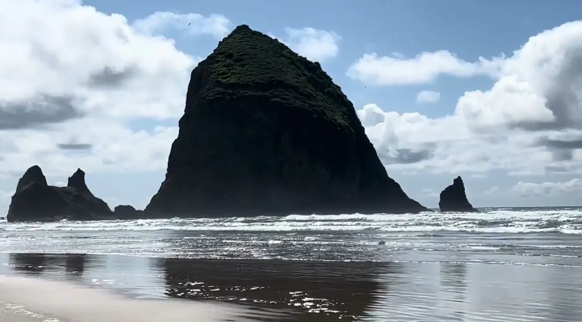 Haystack Rock rising 235 feet from the surf at Cannon Beach