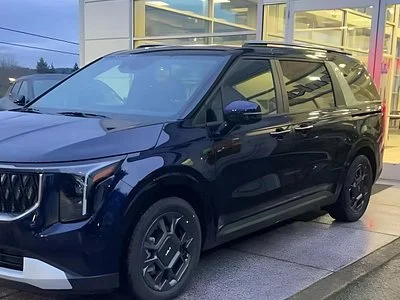 Dark navy Kia Carnival minivan